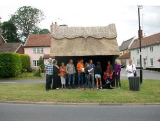 Gathering of villagers outside the new bus shelter