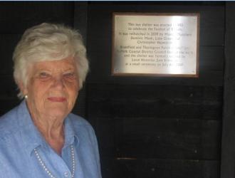 June Brereton admires the plaque